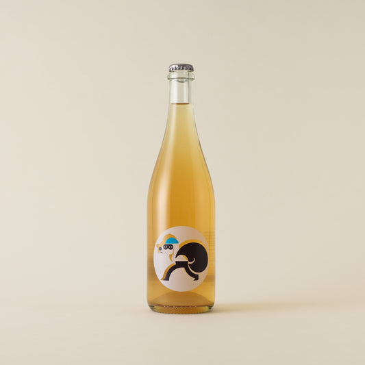 A sparkling wine with gewurztraminer and riesling wine inside. A white circular label with a dog icon robbing. A silver cap on top.