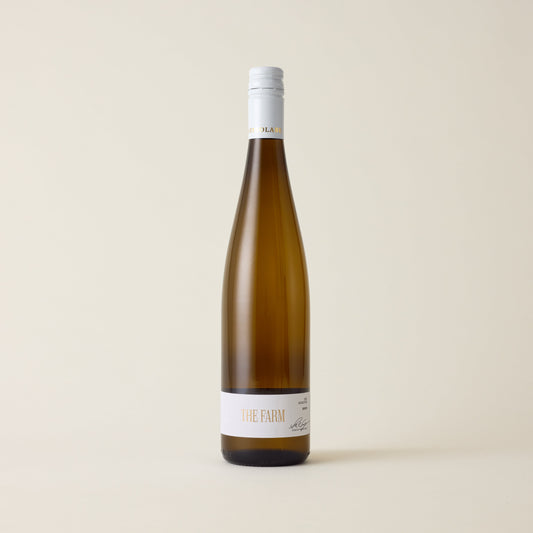 Wine wine bottle with Riesling wine inside. A white label with The Farm logo in the centre. A white screwtop cap and neck label with Astrolabe logo wrapped around.