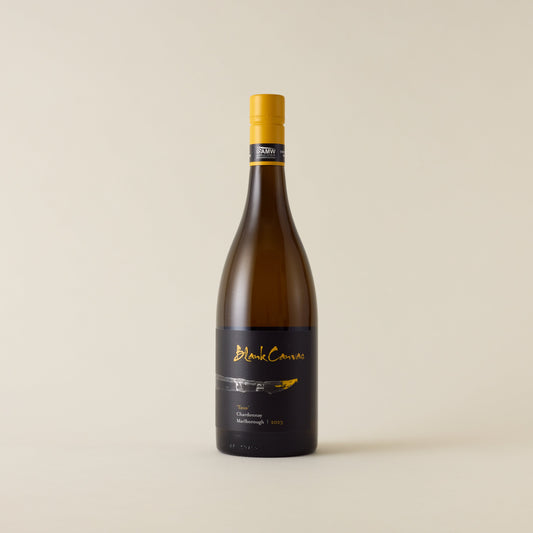 White wine bottle with chardonnay wine inside. A white label with Blank Canvas logo and paint brush design. A yellow screwtop and neck label.