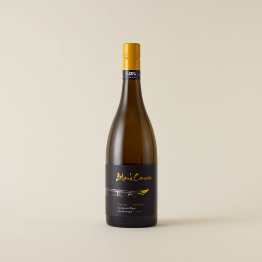 White wine bottle with sauvignon blanc wine inside. A black label with Blank Canvas logo and paint brush design. A yellow screwtop and neck label.