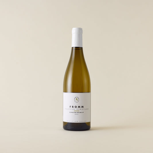 White wine bottle with chardonnay wine inside. A white label with Fromm logo. A white screwtop and neck label.
