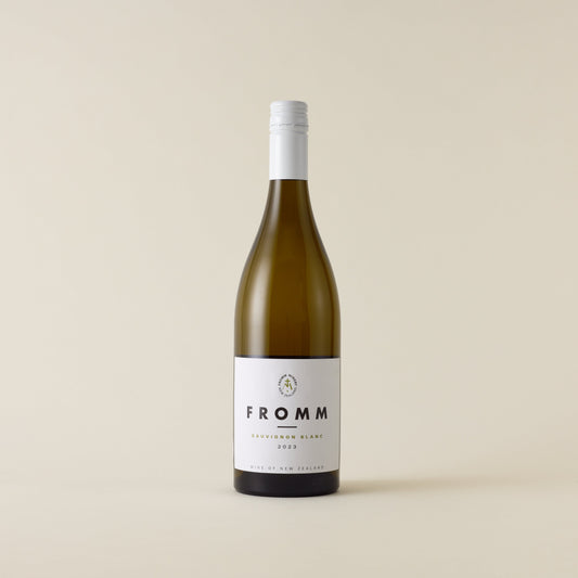 White wine bottle with sauvignon blanc wine inside. A white label with Fromm logo. A white screwtop and neck label.