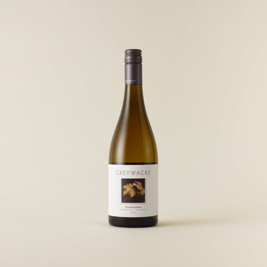 White wine bottle with chardonnay wine inside. A white label with Greywacke logo and image of vine leaf. A matte grey screwcap and neck label.