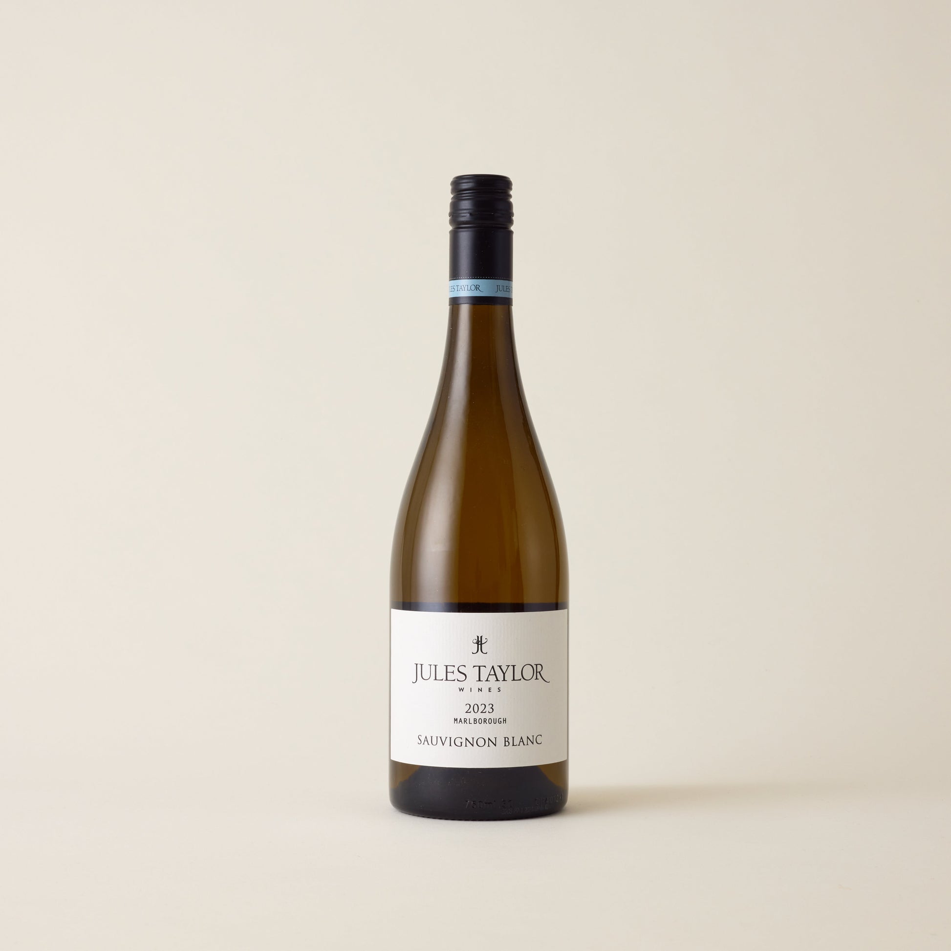 White wine bottle with Sauvignon Blanc wine inside. A White label with Jules Taylor logo. A black screwtop and logo on neck label.