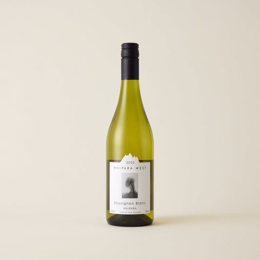 White wine bottle with sauvignon blanc wine inside. A white label with Waipara West logo. A black screwcap and neck label.