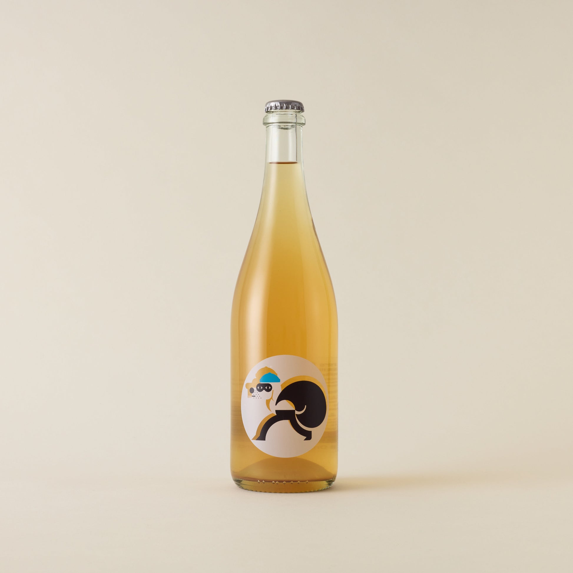 A sparkling wine with gewurztraminer and riesling wine inside. A white circular label with a dog icon robbing. A silver cap on top.