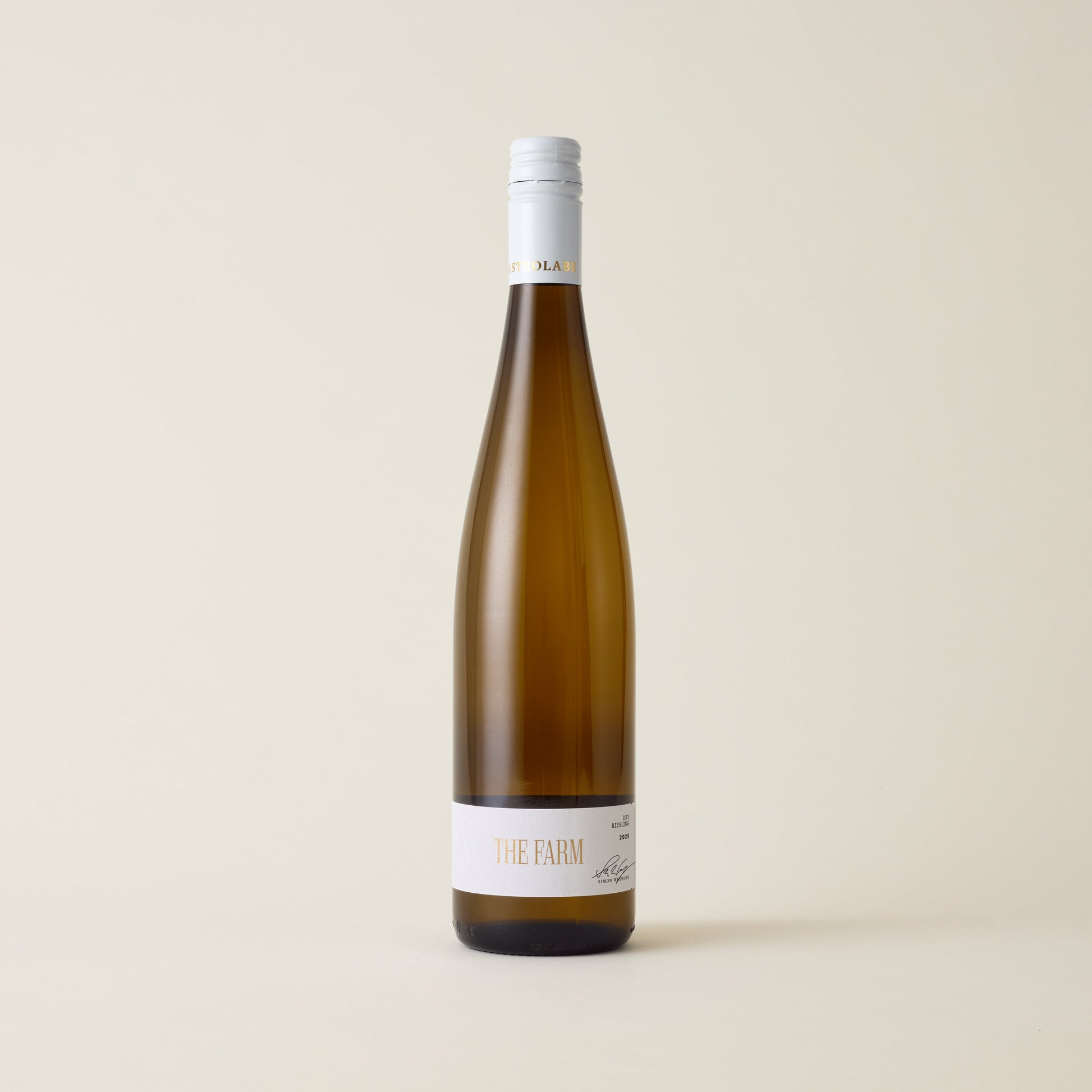 Wine wine bottle with Riesling wine inside. A white label with The Farm logo in the centre. A white screwtop cap and neck label with Astrolabe logo wrapped around.