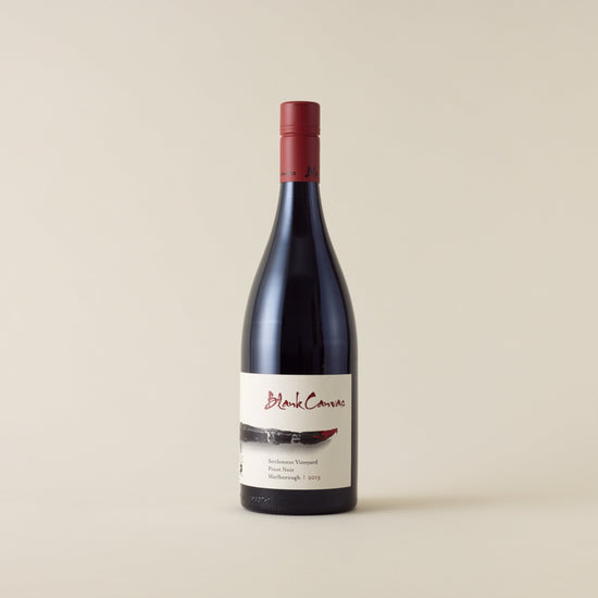 Red wine bottle with pinot noir wine inside. A white label with Blank Canvas logo and paint brush design. A red screwtop and neck label.
