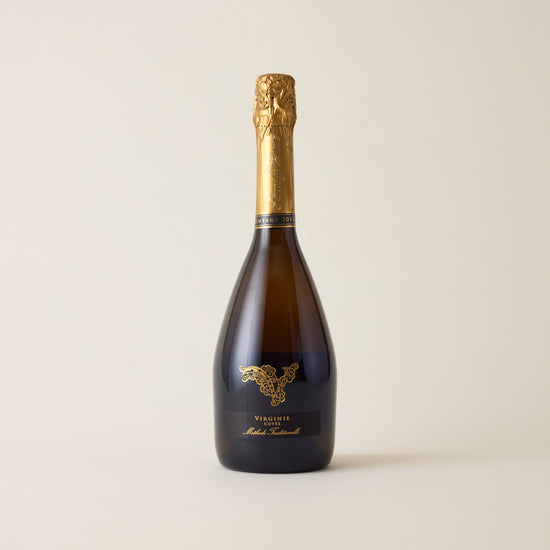 Sparkling wine bottle with Chardonnay wine inside. A Black label with No1 family estate logo. A gold foil cap and neck label. 