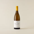 White wine bottle with chardonnay wine inside. A white label with Dog Point logo. A yellow screwtop and neck label. 