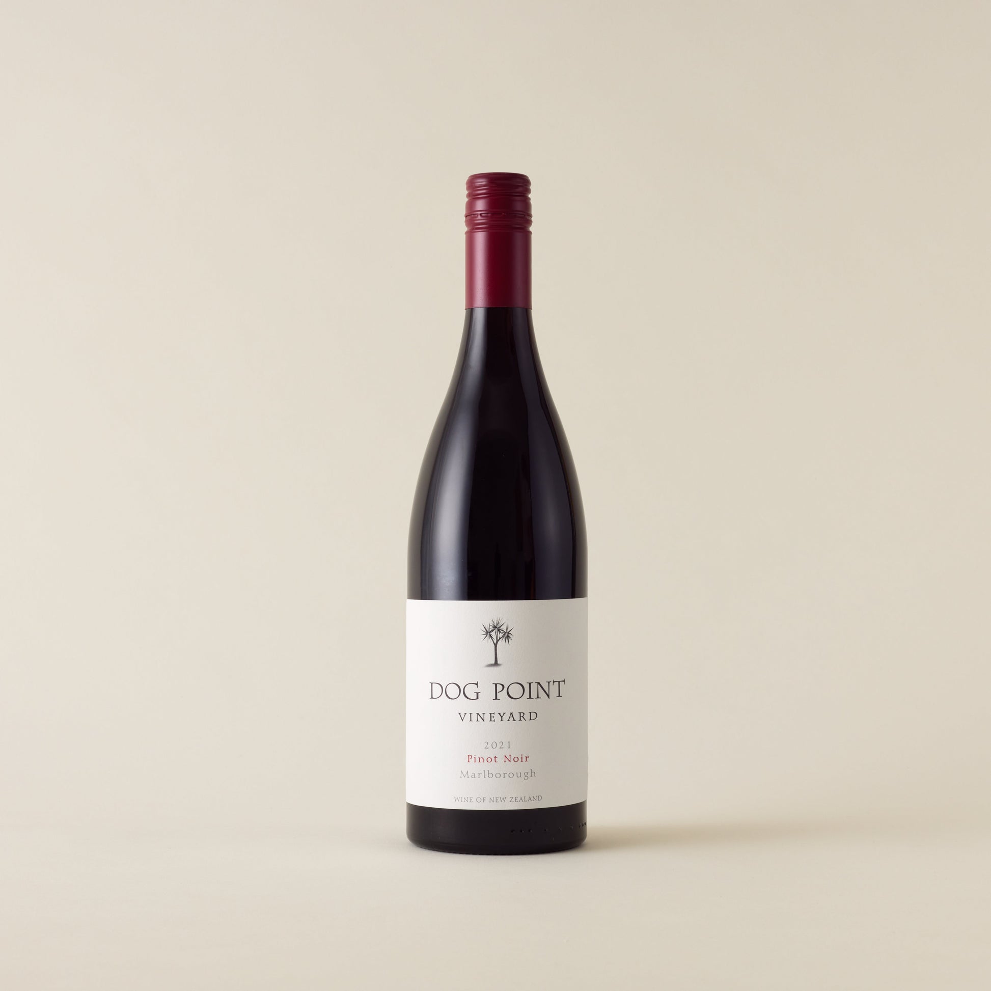 Red wine bottle with pinot noir wine inside. A white label with Dog Point logo. A red screwtop and neck label. 