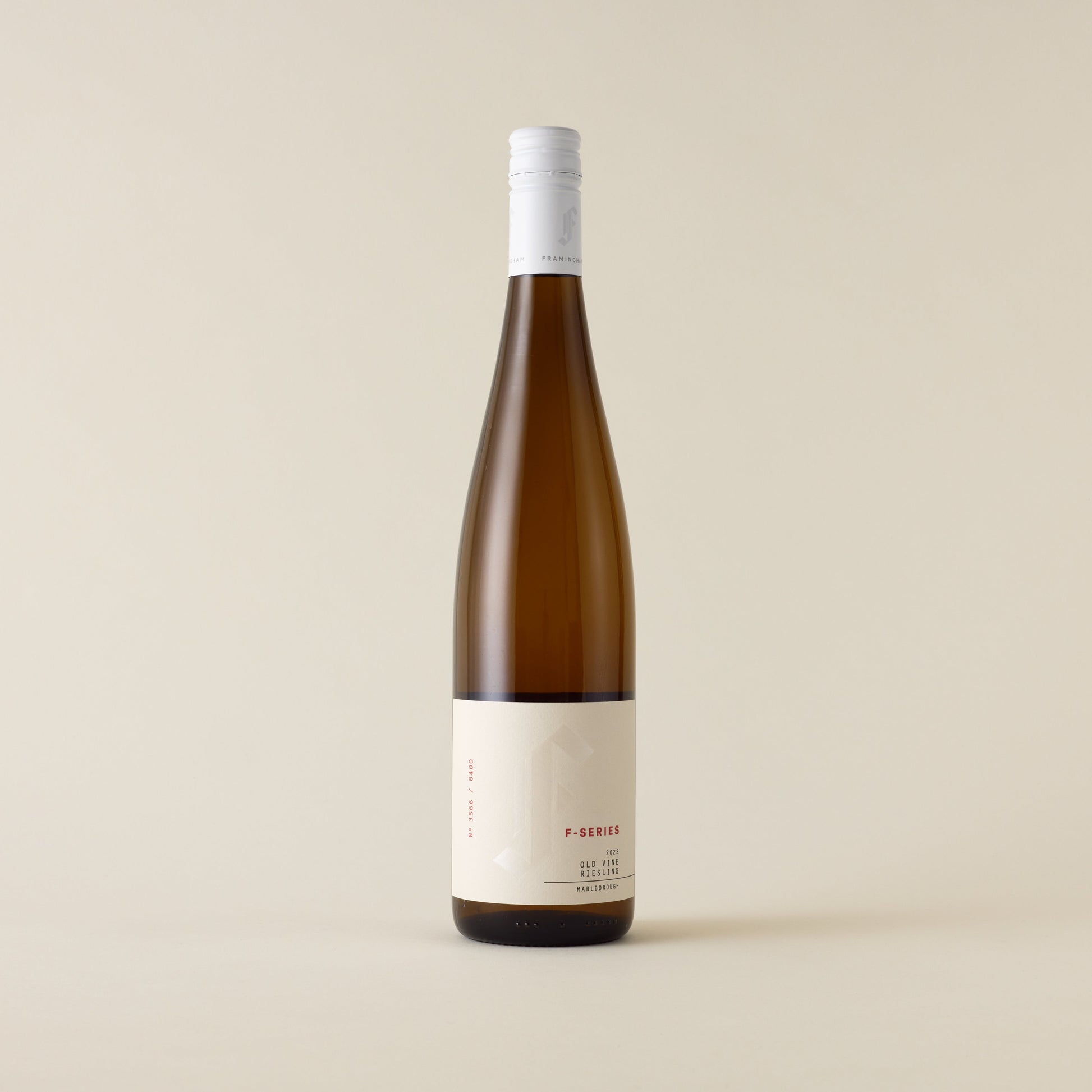 White wine bottle with Riesling wine inside. A cream label with Framingham F logo. A white screwcap and neck label.