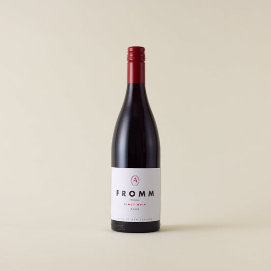 Red wine bottle with pinot noir wine inside. A white label with Fromm logo. A red screwtop and neck label. 