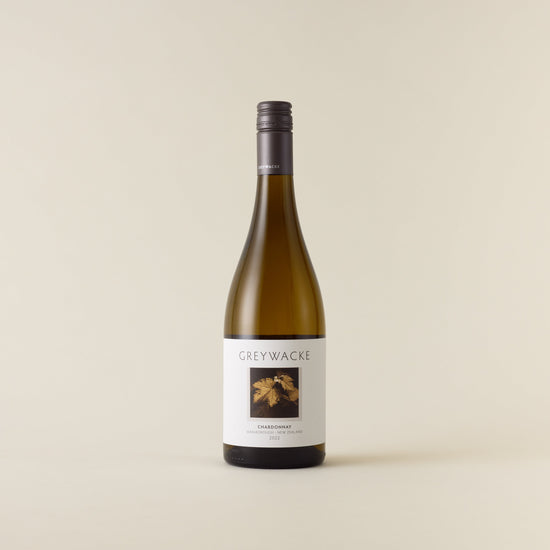 White wine bottle with chardonnay wine inside. A white label with Greywacke logo and image of vine leaf. A matte grey screwcap and neck label.