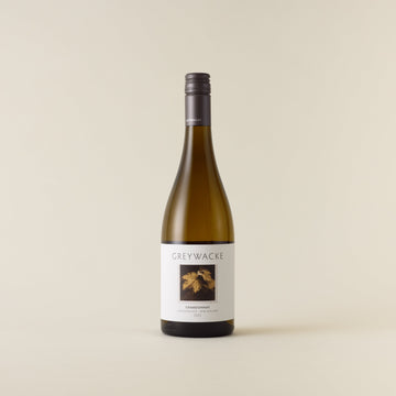 White wine bottle with chardonnay wine inside. A white label with Greywacke logo and image of vine leaf. A matte grey screwcap and neck label.