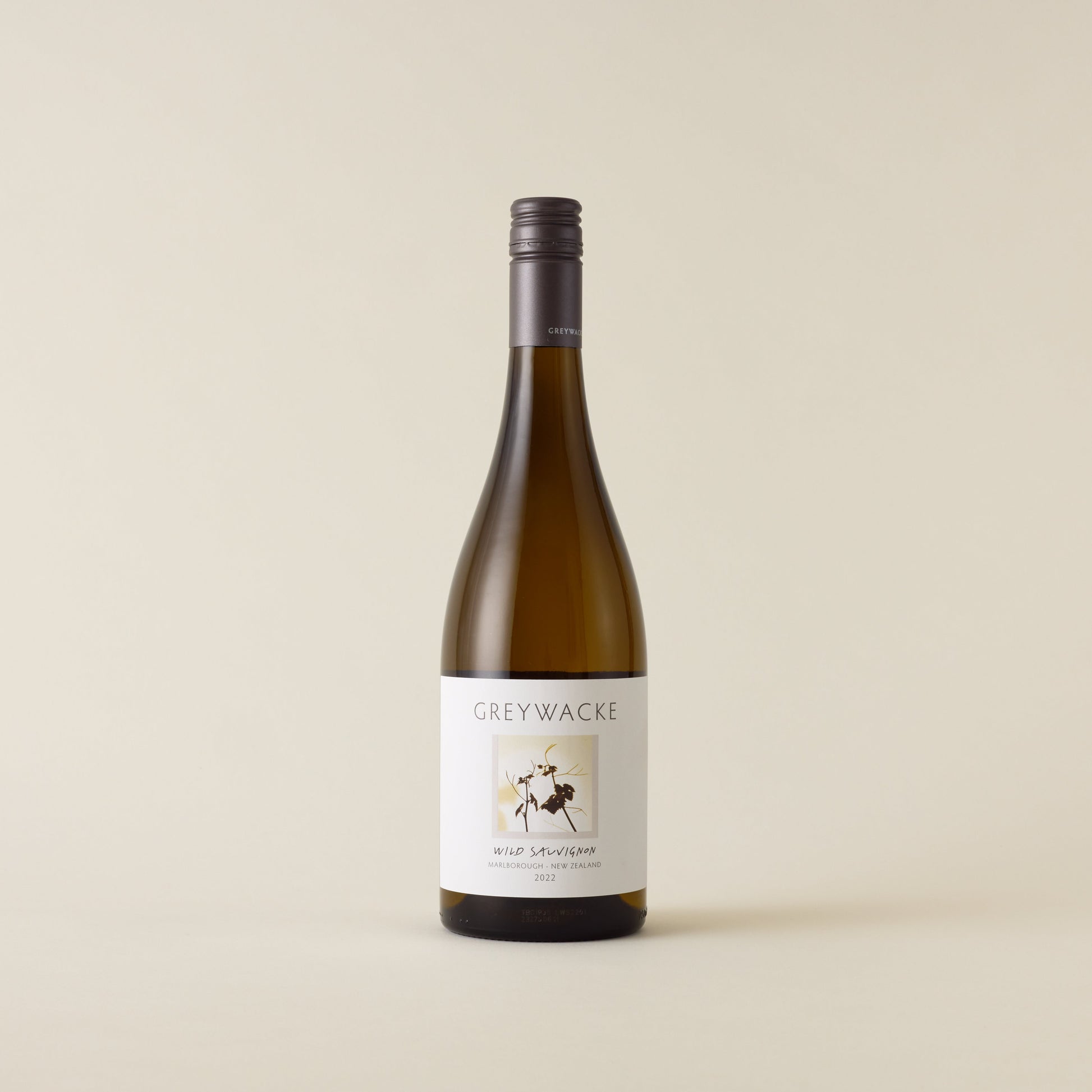 White wine bottle with Sauvignon Blanc wine inside. A white label with Greywacke logo and image of vine leaf. A matte grey screwcap and neck label.