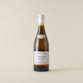 White wine bottle with Chardonnay wine inside. A white label with Kumeu River logo. A white screwcap and neck label.
