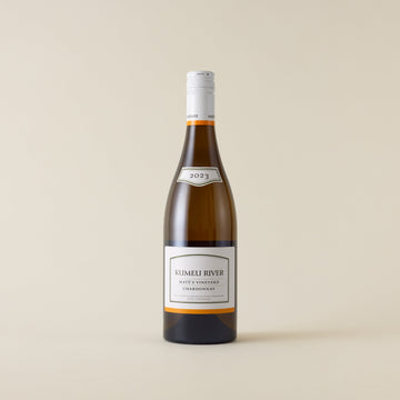 White wine bottle with Chardonnay wine inside. A white label with Kumeu River logo. A white screwcap and neck label.