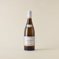 White wine bottle with Chardonnay wine inside. A white label with Kumeu River logo. A white screwcap and neck label.