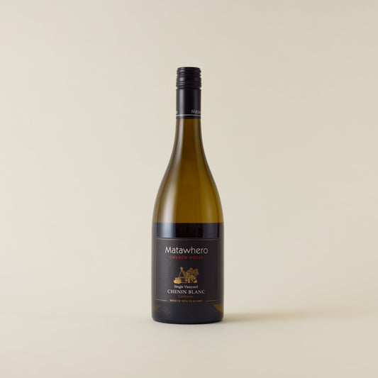 White wine bottle with chardonnay wine inside. A black label with Matawhero logo. A black screwcap and neck label.