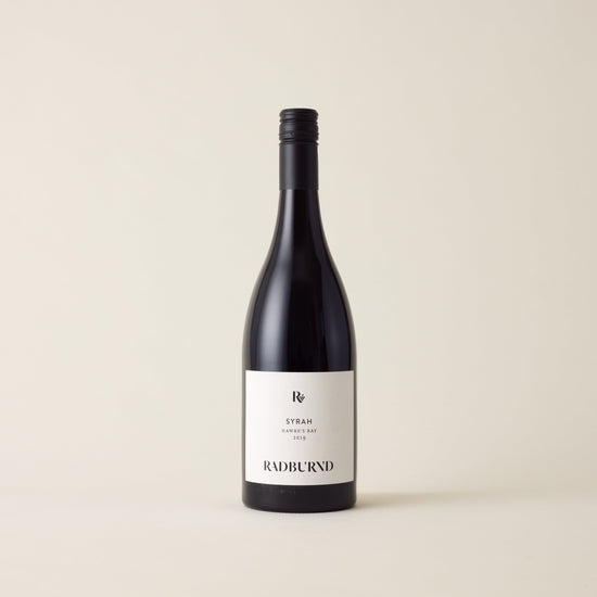 Red wine bottle with Syrah wine inside. A White label with Radburnd logo. A black screwtop and neck label.