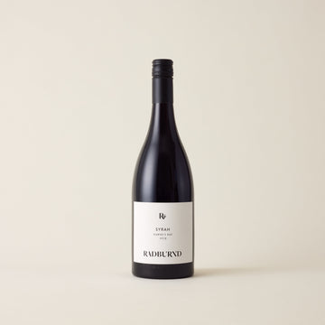 Red wine bottle with Syrah wine inside. A White label with Radburnd logo. A black screwtop and neck label.