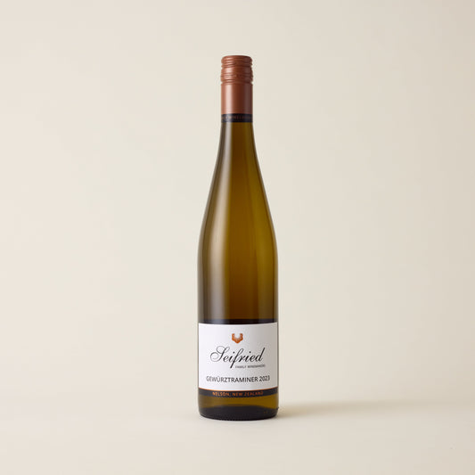 White wine bottle with Gewurztraminer wine inside. A white label with Seifried logo. A black screwcap and neck label.
