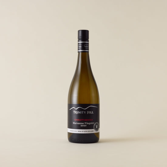 White wine bottle with Marsanne Viognier wine inside. A black label with Trinity Hill logo. A black screwcap and neck label.