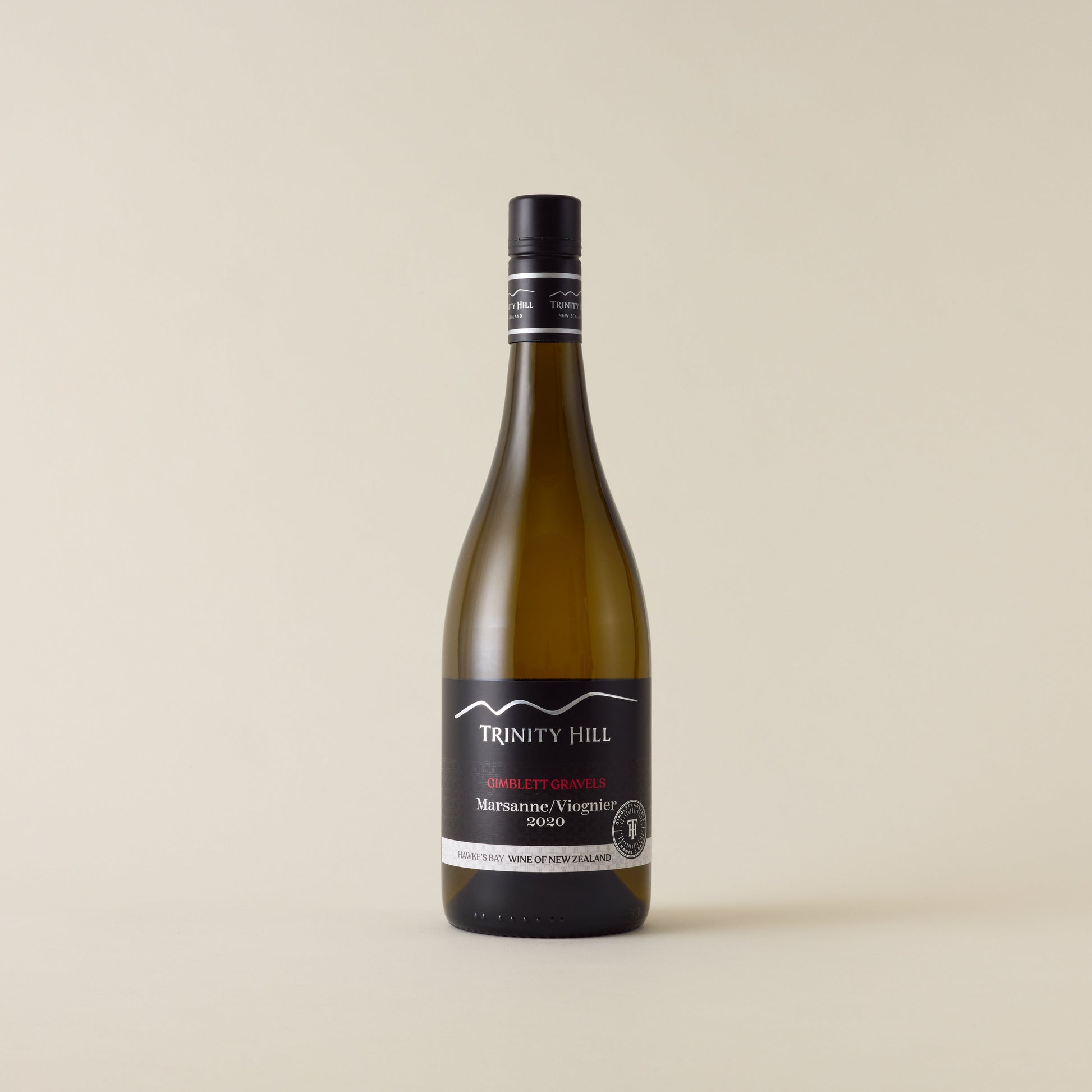 White wine bottle with Marsanne Viognier wine inside. A black label with Trinity Hill logo. A black screwcap and neck label.