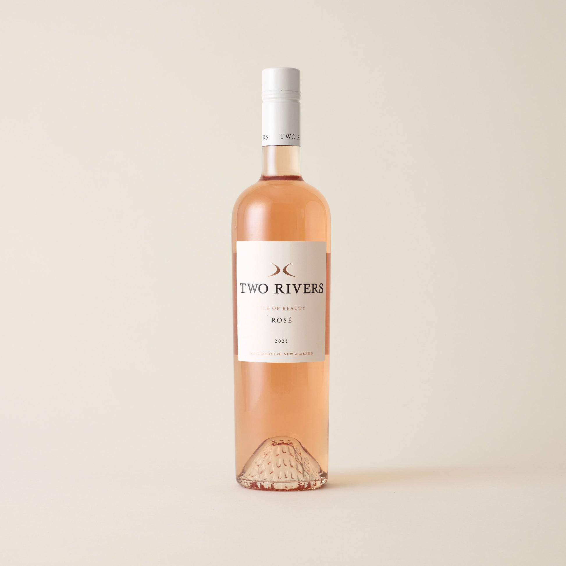 Rose wine bottle with Syrah wine inside. A white label with Two Rivers logo. A white screwtop and logo on neck label.