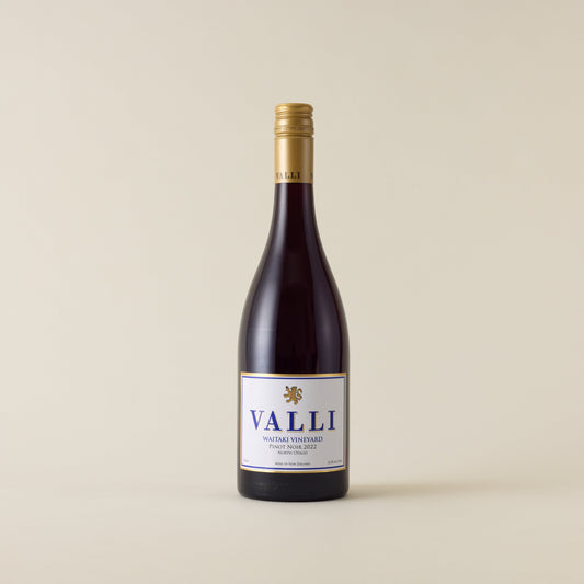 Red wine bottle with pinot noir wine inside. A white label with Valli logo. A gold screwtop and neck label. 